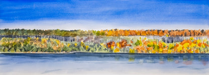 Panoramic view of a cliff across the river with autumn foliage reflected in the water.